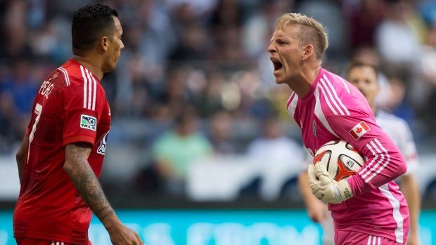 Whitecaps goalkeeper David Ousted yells at ex-Dallas striker Blas Perez after some gamesmanship in the box. The two are now teammates.