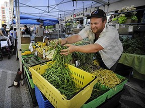 Brett Lawton doles out his fresh produce at the Yaletown Farmers' Market last week. The farm-to-table movement continues to blossom in B.C. (Mark van Manen, PNG)