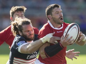 Canada's James Pritchard (right) is tackled by USA's Todd Clever during second half Rugby World Cup Qualifying action in Toronto on Saturday August 24, 2013. THE CANADIAN PRESS/Chris Young