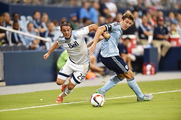 Octavio Rivero battles for the ball against Sporting KC defender Matt Besler during the first half at Sporting Park. Peter G. Aiken-USA TODAY Sports