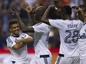 VANCOUVER  August 08 2015. L-R. Whitecaps FC #13 Cristian Techera  celebrates his second goal on Real Salt Lake FC with teammate #44 Pa-Modou Kah and #28 Gershon Koffie during MLS soccer action at BC Place, Vancouver August 08 2015.  Gerry Kahrmann  /  PNG staff photo)