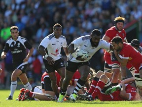 Peni Ravai of Fiji is tackled by Phil Mack of Canada during the International match between Fiji and Canada at Twickenham Stoop on September 6, 2015 in London, England.  (Photo by Steve Bardens/Getty Images for Harlequins)