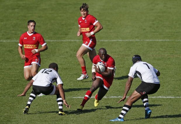 Canada's flanker Nanyak Dala (2nd R) makes a break during the international rugby union friendly match between Canada and Fiji, ahead of the 2015 Rugby World Cup, at The Stoop in Twickenham, west of London, on September 6, 2015. AFP PHOTO / ADRIAN DENNISADRIAN DENNIS/AFP/Getty Images