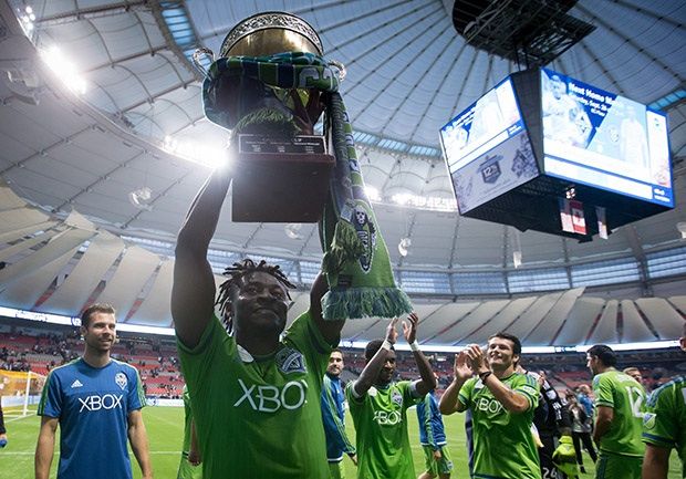 Seattle Sounders' Obafemi Martins hoists the Cascadia Cup. /9THE CANADIAN PRESS/Darryl Dyck)