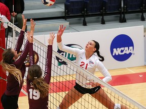 SFU freshman Tessa May plays a tip at the net over SPU defenders Jessica Boyle (19) and Dani Johnson (8)  in a GNAC Volleyball game at West Gym, Burnaby B.C. September 17 2015. Photo: Ron Hole