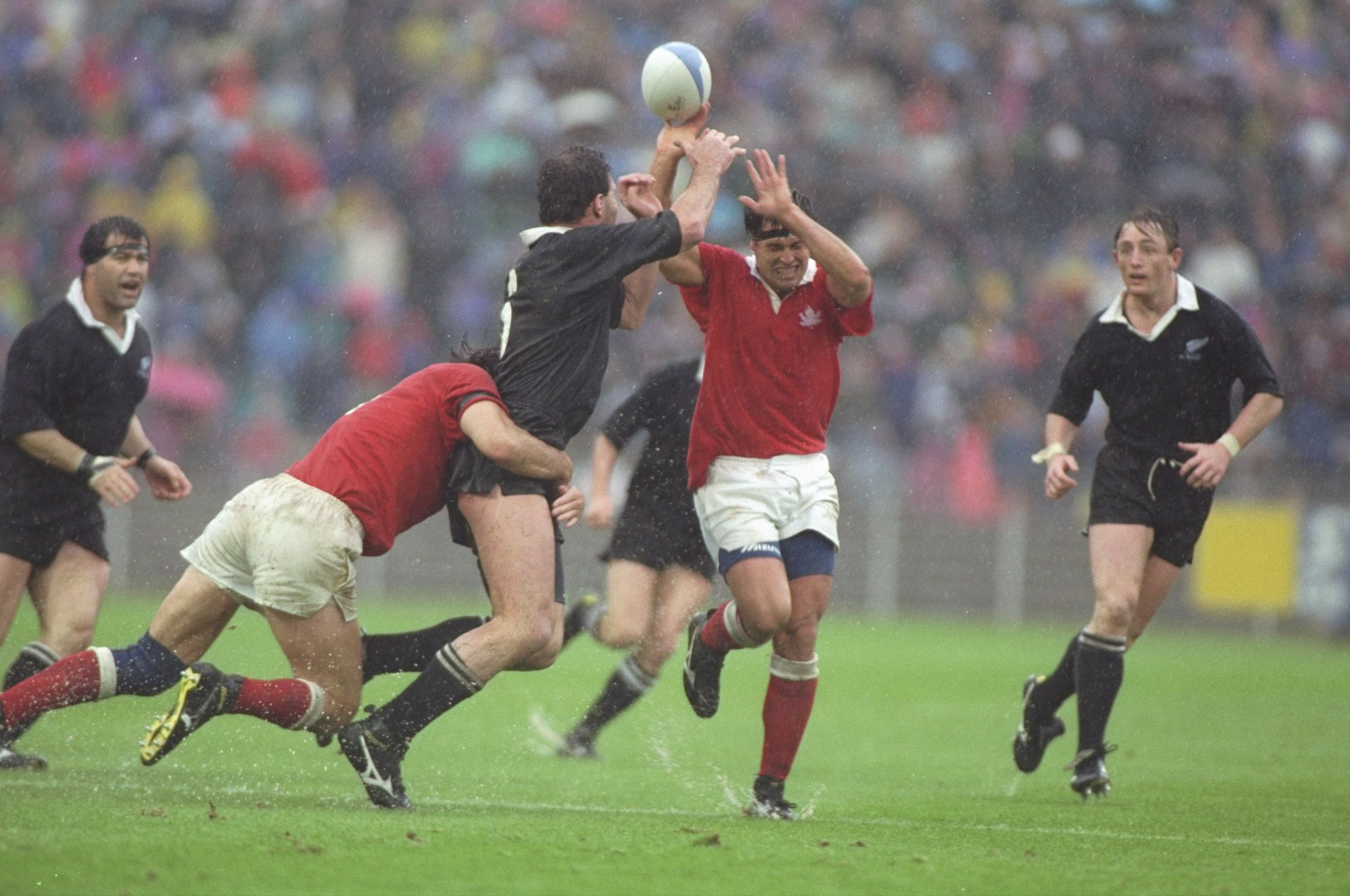 20 Oct 1991:  Alan Whetton of New Zealand tries to pass over Canada's Dave Spiers during the quarter-final in Lille, France. New Zealand won the match 29-13.  Simon Bruty/Allsport/Getty Images