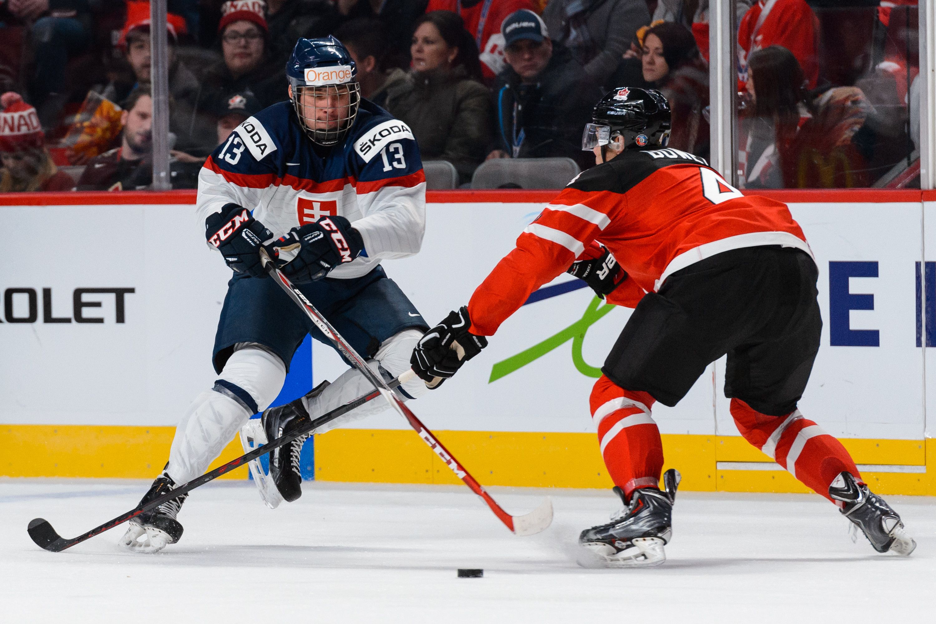 MONTREAL, QC - DECEMBER 26:  Radovan Bondra #13 of Team Slovakia carries the puck near Madison Bowey #4 of Team Canada during the 2015 IIHF World Junior Hockey Championship game at the Bell Centre on December 26, 2014 in Montreal, Quebec, Canada.  (Photo by Minas Panagiotakis/Getty Images)