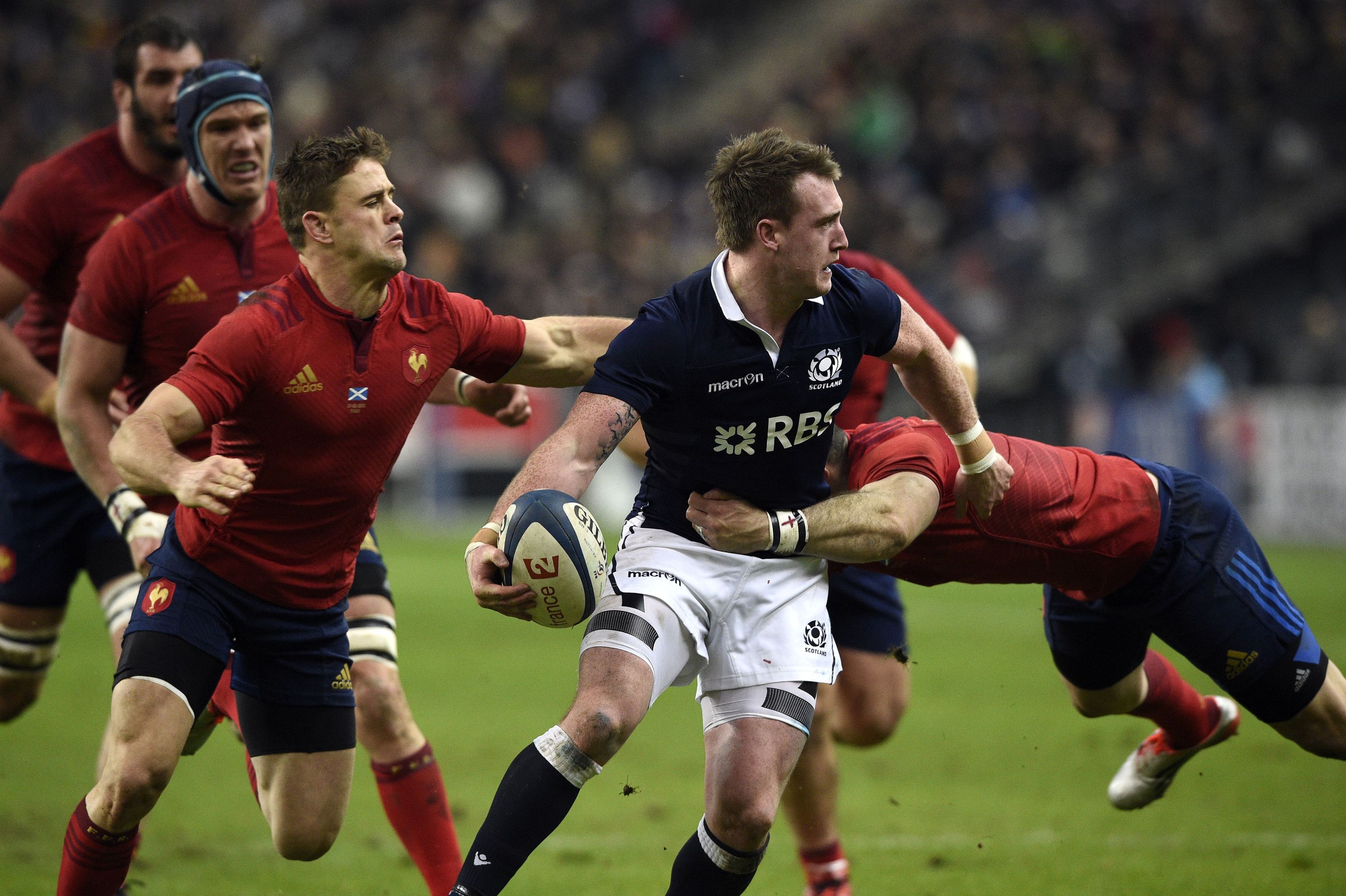 Scotland's fullback Stuart Hogg (C) is tackled   during the Six Nations international rugby union match between France and Scotland on February 7, 2015 at the Stade de France, north of Paris. AFP PHOTO / FRANCK FIFE        (Photo credit should read FRANCK FIFE/AFP/Getty Images)