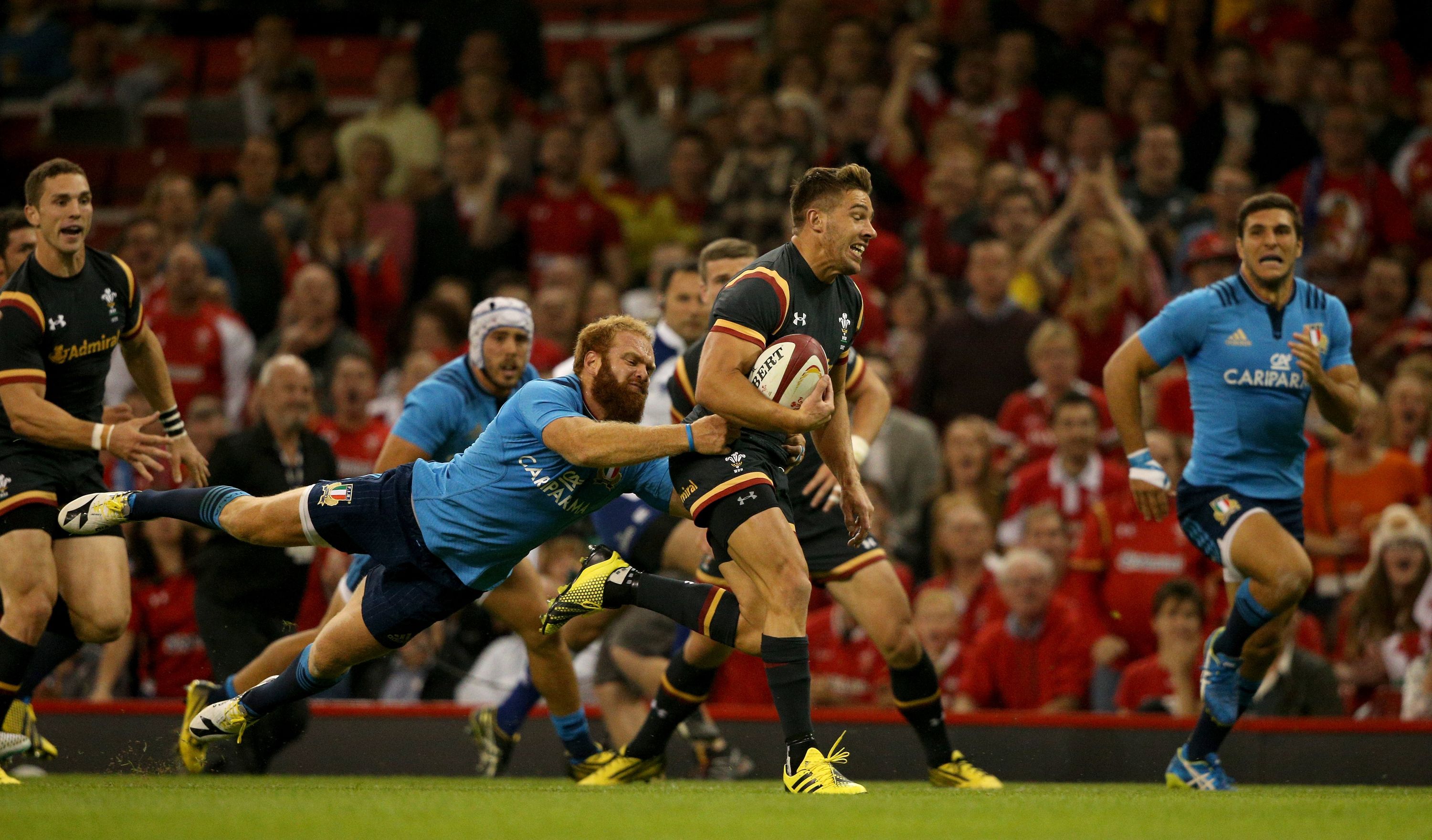 CARDIFF, WALES - SEPTEMBER 05:  Wales player Rhys Webb breaks the tackle of Gonzalo Garcia of Italy during the International match between Wales and Ireland at Millennium Stadium on September 5, 2015 in Cardiff, Wales.  (Photo by Stu Forster/Getty Images)