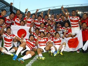 Japan players celebrate after the win over South Africa during the Rugby World Cup 2015 Pool B match between South Africa and Japan at Brighton Community Centre on September 19, 2015 in Brighton, England. (Photo by Steve Haag/Gallo Images/Getty Images)