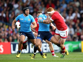 Connor Braid powers into Tommaso Allan during the Canada vs. Italy match. Braid was later forced from the field with what turned out to be a broken jaw. (Photo by Jan Kruger/Getty Images)