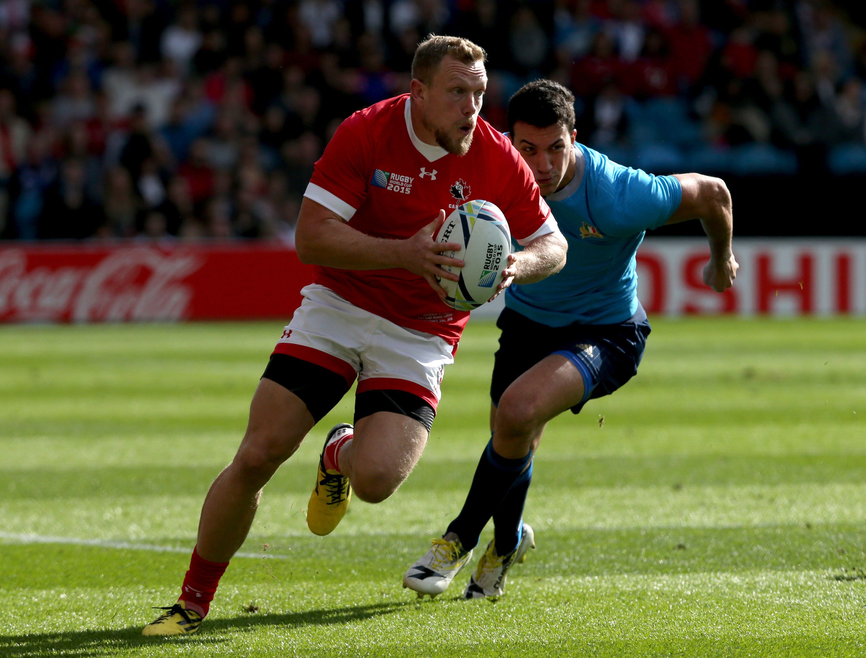 LEEDS, ENGLAND - SEPTEMBER 26 : Phil MacKenzie of Canada out runs Leonardo Sarto of Italy during the 2015 Rugby World Cup Pool D match between Italy and Canada at Elland Road on September 26, 2015 in Leeds England. (Photo by Mark Runnacles/Getty Images)