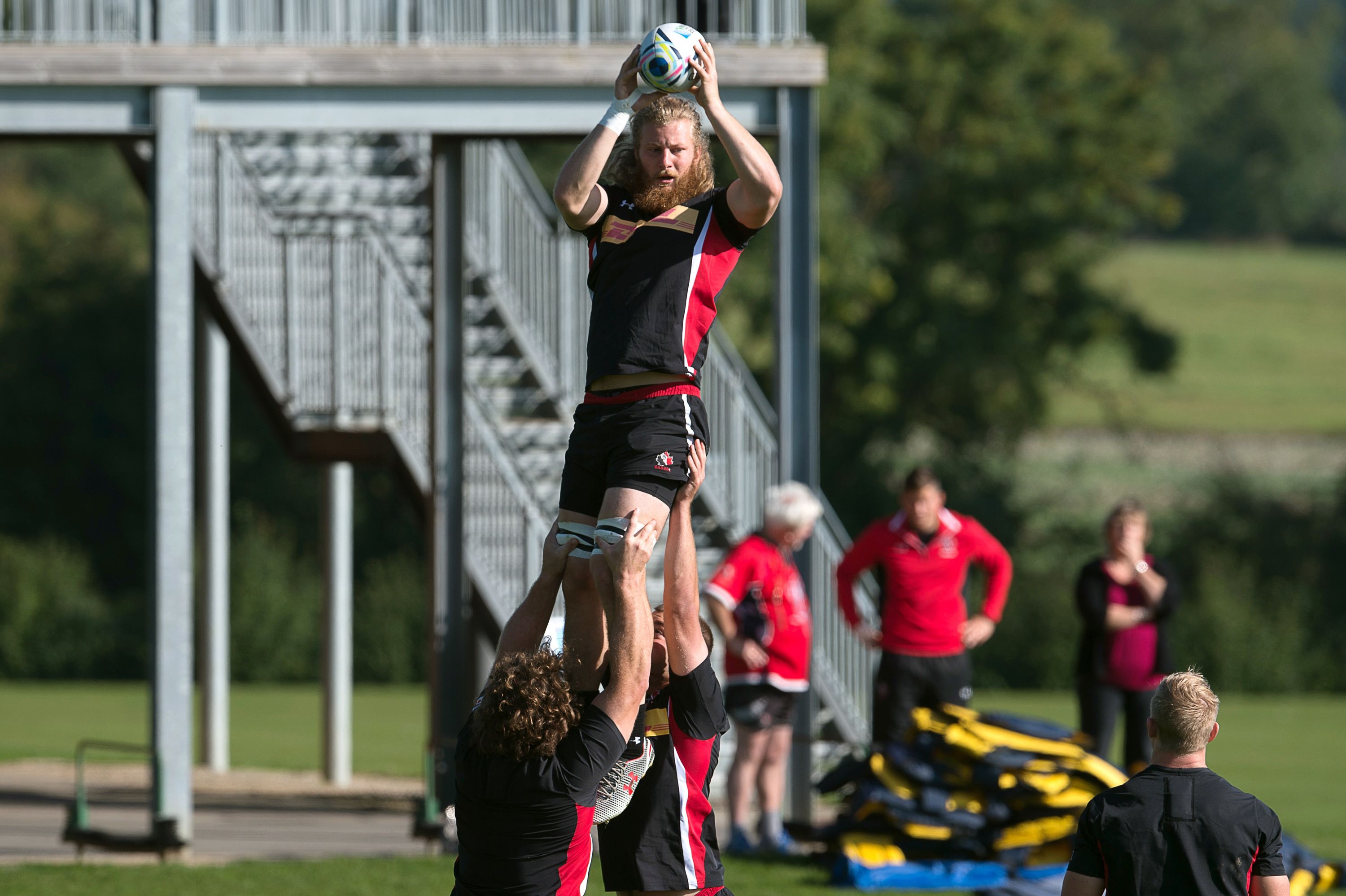 Canada's lock Evan Olmstead (up) practices catching the ball in a line out  during a team training session at Leicester Grammar School in Leicester on September 28, 2015, during the 2015 Rugby Union World Cup. AFP PHOTO / BERTRAND LANGLOIS RESTRICTED TO EDITORIAL USE        (Photo credit should read BERTRAND LANGLOIS/AFP/Getty Images)