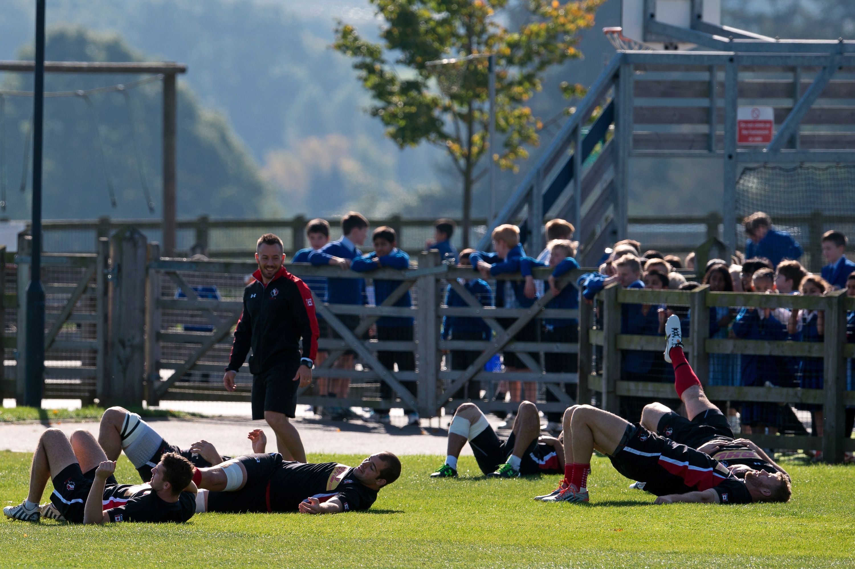 Canada's players stretch  during a team training session at Leicester Grammar School in Leicester on September 28, 2015, during the 2015 Rugby Union World Cup. AFP PHOTO / BERTRAND LANGLOIS RESTRICTED TO EDITORIAL USE        (Photo credit should read BERTRAND LANGLOIS/AFP/Getty Images)