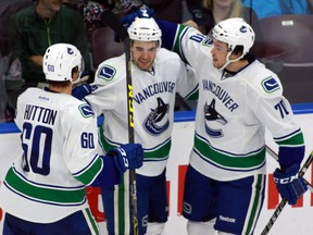 Vancouver Canucks' Reid Gardiner (centre) celebrates his goal with his teammates Ben Hutton (60) and Jonathan Martin ( 70) during the third period NHL rookie action in Penticton, B.C., on Sunday, September 13, 2015. THE CANADIAN PRESS/Jeff Bassett