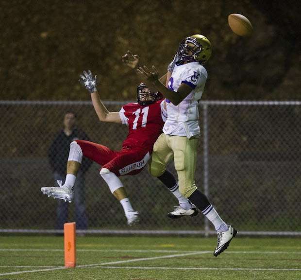 St. Thomas More's Jacob Chiu (left) sticks to Vancouver College wide receiver Rysen John during AAA football clash Friday at Burnaby Lakes. (Gerry Kahrmann, PNG)