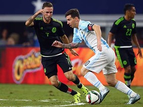 Lionel Messi dribbles the ball against Mexico's Miguel Layun last night in Texas.