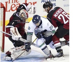 Ryely McKinstry, shown here battling in front of the Vancouver net and goalie Payton Lee in the season opener against Seattle, is the latest Giant to be sidelined. He left Sunday's 5-4 win in Saskatoon with an upper body injury. (Province Files.)