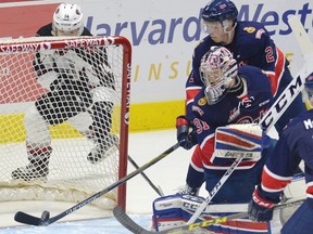 Regina Pats goaltender Tyler Brown watches as teammate Sergey Zborovskiy keeps the puck from entering the net against the Vancouver Giants on Friday at the Brandt Centre. (Regina Leader-Post photo.)