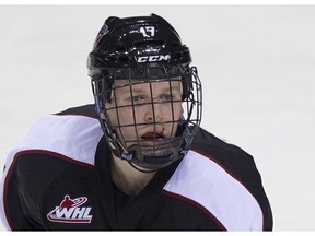 Tyler Benson was forced to wear a full cage in the Giants' game Friday against Seattle after taking a puck in the mouth in warm-up. (Province photo.)