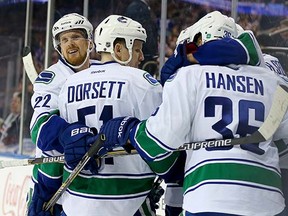 Daniel Sedin, Derek Dorsett and Jannik Hansen celebrate a goal against the New York Rangers in February.