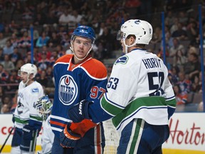 Connor McDavid of the Edmonton Oilers exchanges words with Bo Horvat of the Vancouver Canucks on October 1, 2015 at Rexall Place in Edmonton, Alberta, Canada. (Photo by Andy Devlin/NHLI via Getty Images)