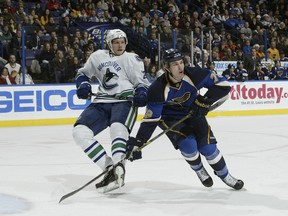Adam Cracknell, back in his Blues days, tussles with current Vancouver teammate Alex Edler
during this 2010 game. Cracknell faces his former team tonight at Rogers Arena. (Getty Files.)