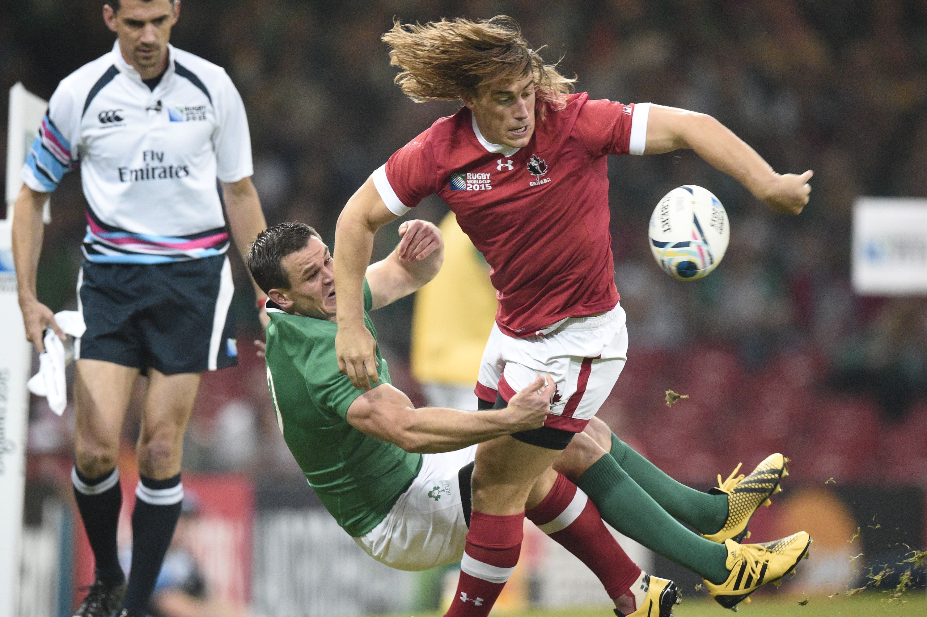 Canada's wing Jeff Hassler (R) is tackled by Ireland's fly half Jonathan Sexton during a Pool D match of the 2015 Rugby World Cup between Ireland and Canada at the Millenium stadium in Cardiff, south Wales on September 19, 2015. AFP PHOTO / DAMIEN MEYER RESTRICTED TO EDITORIAL USE, NO USE IN LIVE MATCH TRACKING SERVICES, TO BE USED AS NON-SEQUENTIAL STILLS        (Photo credit should read DAMIEN MEYER/AFP/Getty Images)