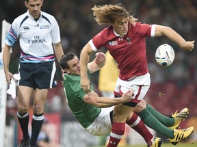 Canada's wing Jeff Hassler is tackled by Ireland's fly half Jonathan Sexton during a Pool D match of the 2015 Rugby World Cup between Ireland and Canada at the Millenium stadium in Cardiff, Wales on September 19, 2015.
       (DAMIEN MEYER/AFP/Getty Images)
