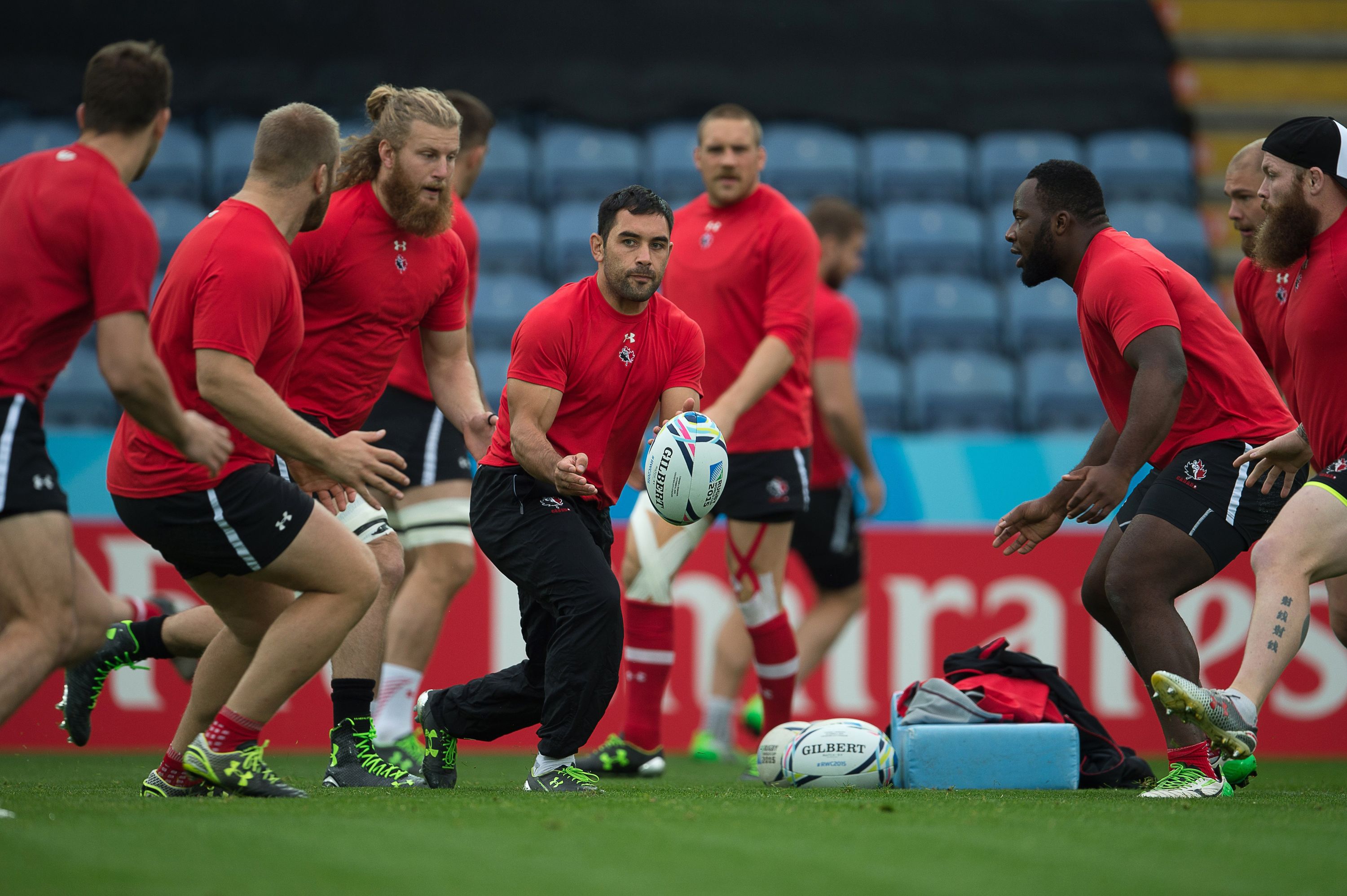 Canada's scrum half Phil Mack (C) passes the ball during a captain's run training session in Leicester, central England, on October 5, 2015, on the eve of their 2015 Rugby Union World Cup match against Romania. AFP PHOTO / BERTRAND LANGLOIS RESTRICTED TO EDITORIAL USE        (Photo credit should read BERTRAND LANGLOIS/AFP/Getty Images)