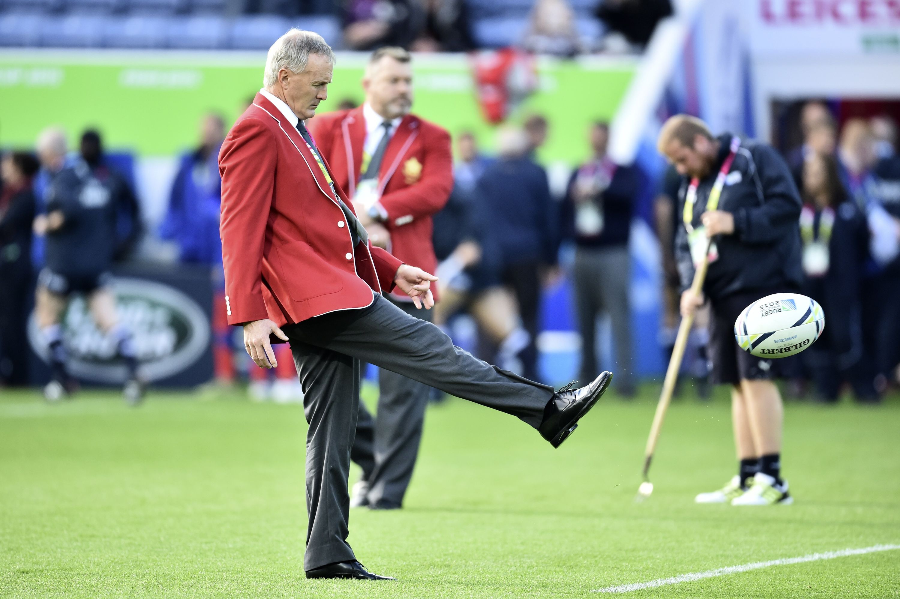 Canada's head coach Kieran Crowley kicks a ball before the start of the Pool D match of the 2015 Rugby World Cup between Canada and Romania at Leicester City Stadium in Leicester, central England, on October 6, 2015.  AFP PHOTO / BERTRAND LANGLOIS RESTRICTED TO EDITORIAL USE, NO USE IN LIVE MATCH TRACKING SERVICES, TO BE USED AS NON-SEQUENTIAL STILLS        (Photo credit should read BERTRAND LANGLOIS/AFP/Getty Images)
