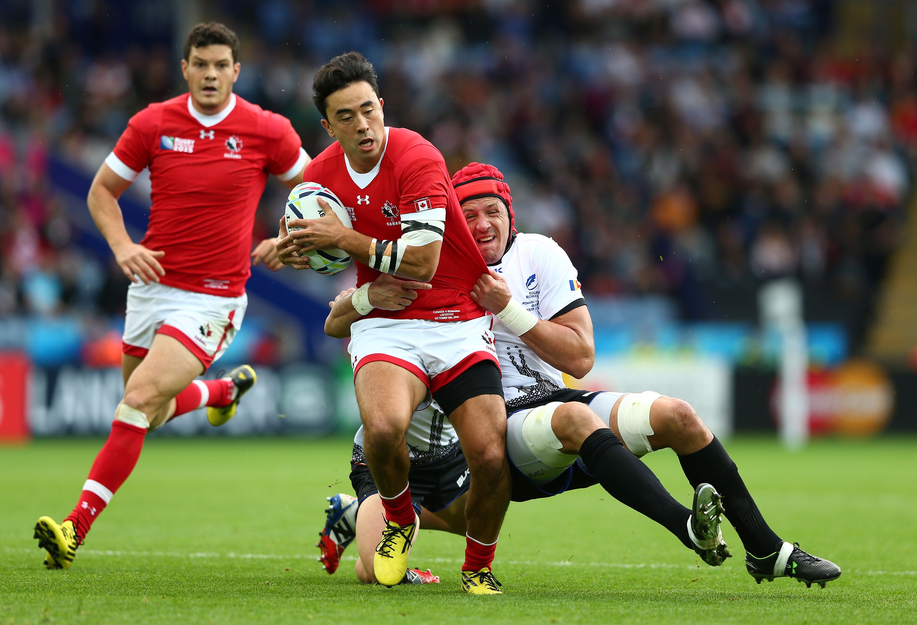 LEICESTER, ENGLAND - OCTOBER 06:  Nathan Hirayama of Canada is held up by Mihai Macovei of Romania during the 2015 Rugby World Cup Pool D match between Canada and Romania at Leicester City Stadium on October 6, 2015 in Leicester, United Kingdom.  (Photo by Michael Steele/Getty Images)