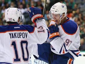 Connor McDavid of the Edmonton Oilers celebrates his first career NHL goal with Nail Yakupov against the Dallas Stars in the second period at American Airlines Center on Tuesday in Dallas, Texas.