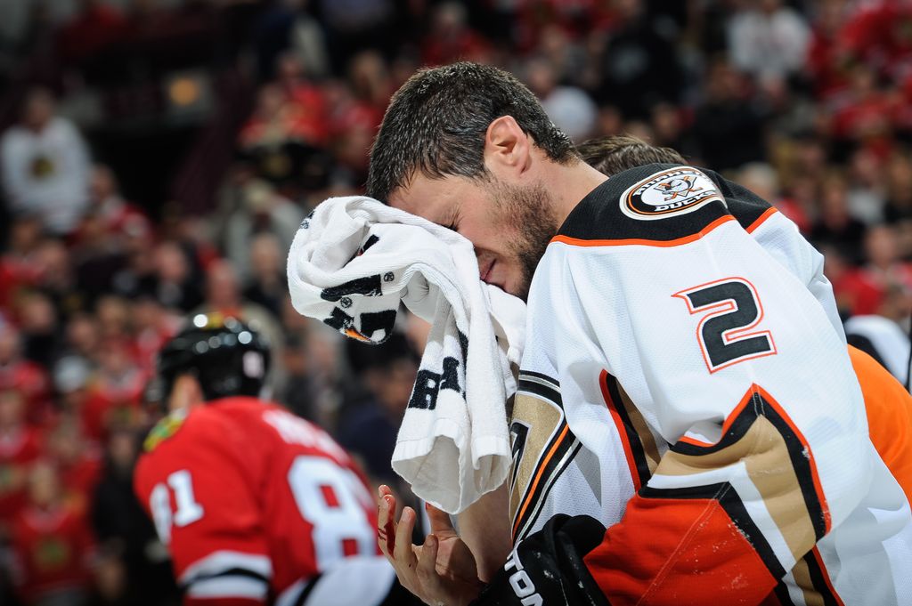 CHICAGO, IL - OCTOBER 26:  Kevin Bieksa #2 of the Anaheim Ducks holds a towel to his face after being hit with the puck in the third period of the NHL game against the Chicago Blackhawks at the United Center on October 26, 2015 in Chicago, Illinois.  (Photo by Bill Smith/NHLI via Getty Images)