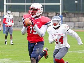 SFU Clan receiver Justin Buren catches a pass in front of Western Oregon defensive back Breeon Moreno Saturday at  Swangard Stadium in Burnaby. (Ron Hole, SFU athletics)