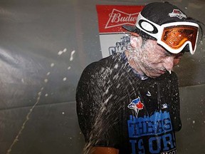 Alcohol drips from the nose of Munenori Kawasaki in  the Toronto Blue Jays clubhouse after they clinched the AL East pennant last night in Baltimore.