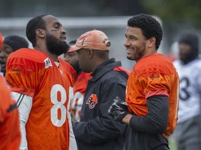 BC Lions receivers Manny Arceneaux (left) and Bryan Burnham talk about catches passes from The Kid. (PNG photo)