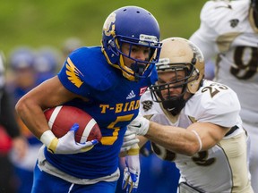 UBC's Marcus Davis prepares to break free from the grasp of Manitoba Bisons' Brett McFarlane during Canada West regular season final for both teams Saturday at Thunderbird Stadium.(Ben Nelms, UBC athletics)