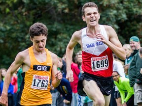 Simon Fraser’s Oliver Jorgensen (right), pictured earlier this season at Seattle’s Sundodger Invite, led his Clan teammates to a program-best second-place finish at the Great Northwest Athletic Conference cross-country championships hosted Saturday by Western Washington University in Bellingham. (Photo — SFU athletics)