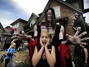 Jordyn Lalanne, 12, gets a big welcome from monster Jim Myers outside the Myers family's annual haunted house, which features some $100,000 in animatronic monsters and other scary effects and has raised thousands of dollars for Ronald McDonald House.