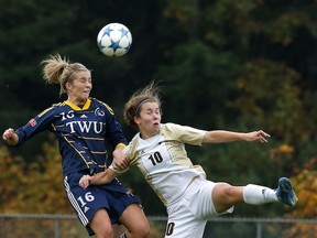 Trinity Western Spartans’ Jenaya Robertson (left) goes skyward to beat Manitoba’s Alanna Shaw during Canada West soccer action Saturday at Rogers Field on TWU’s Langley campus. TWU won 6-0 and challenges UBC for top spot as the conference regular season winds up this coming weekend. (Scott Stewart/Trinity Western athletics)