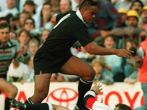 (FILES) A file photo taken on June 18, 1995, shows New Zealand's wing Jonah Lomu as he tries to jump over England's fullback Mike Catt during the Rugby World Cup semi-final match between New Zealand and England in Cape Town. The All Blacks beat England 45-29.  Former England international Mike Catt said Jonah Lomu had "put me on the map" for the "wrong reasons" as he paid a fond tribute to the late New Zealand star. Lomu's sudden death at the age of 40 on November 18, 2015, shocked the international rugby union community and led many to recall his breakthrough performance at the 1995 World Cup in South Africa where he established himself as a global superstar of the sport.  (VINCENT AMALVY/AFP/Getty Images)