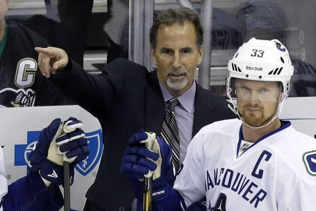 Vancouver Canucks head coach John Tortorella, center, sets up his team behind Canucks' Henrik Sedin (33) in the first period of a NHL hockey game against the Pittsburgh Penguins in Pittsburgh Saturday, Oct. 19, 2013. The Penguins won 4-3 in a shootout (AP Photo/Gene J. Puskar) ORG XMIT: PAGP113