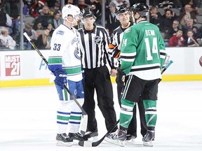 Jamie Benn (right) and Henrik Sedin try to get the ear of the officials during a 2013 game in Dallas.