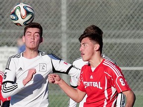 Dr Charles Best's senior forward Chris Bastow (left) wins aerial battle with Burnaby Central's Brady Hughes during semifinal action from 2015 B.C. Triple A boys soccer championships played Friday at Burnaby Lakes. (Nick Procaylo, PNG photo)