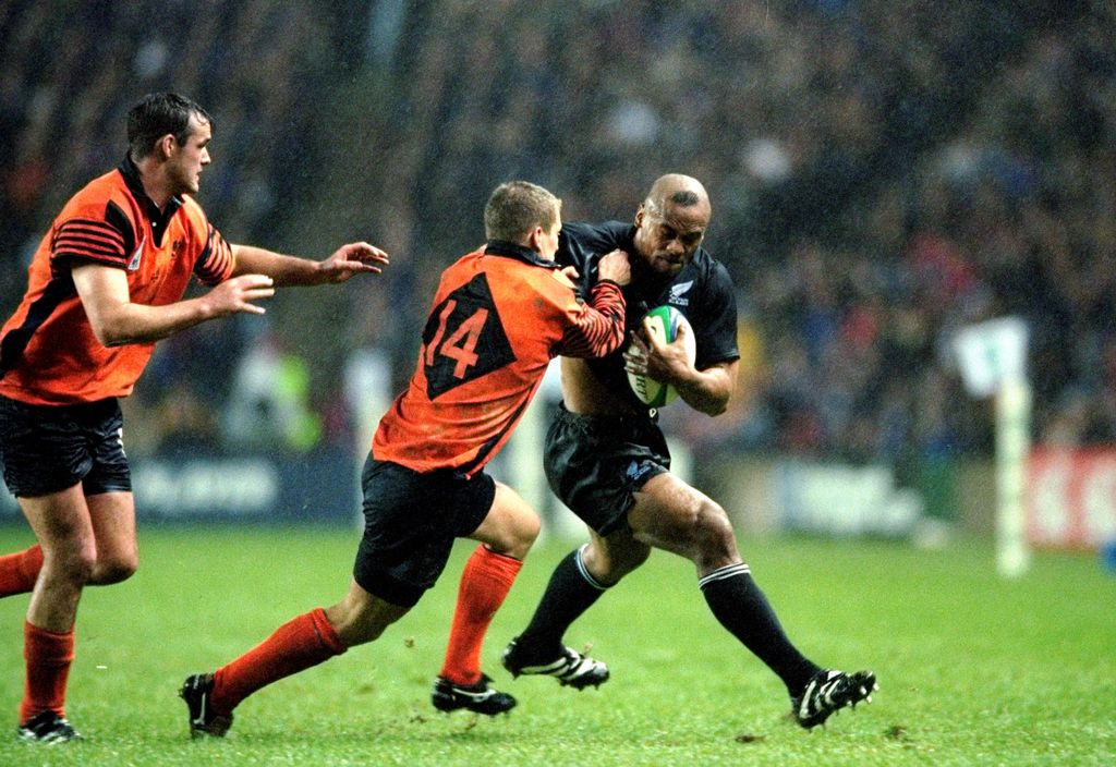 24 Oct 1999:  Jonah Lomu of New Zealand is tackled by Cameron Murray of Scotland in the Rugby World Cup quarter-final match at Murrayfield in Edinburgh, Scotland. New Zealand won 30-18.  Mandatory Credit: Shaun Botterill /Allsport