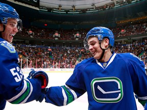 Jake Virtanen and Bo Horvat celebrate Virtanen's first NHL goal.