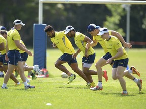 Henry Speight (centre) warms up with team mates during an Australian men's rugby sevens training session at Sydney Academy of Sport on November 9, 2015 in Sydney, Australia.  (Photo by Brett Hemmings/Getty Images)