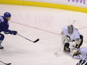 Jannik Hansen hits the post behind Marc Andre-Fleury as the Canucks fall 3-2 to the Penguins at Rogers Arena.