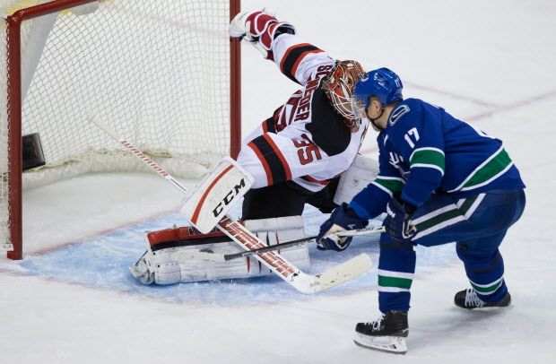 Vancouver Canucks' Radim Vrbata, right, of the Czech Republic, fails to score against New Jersey Devils' goalie Cory Schneider on a penalty shot during the third period of an NHL hockey game in Vancouver, B.C., on Sunday November 22, 2015. THE CANADIAN PRESS/Darryl Dyck